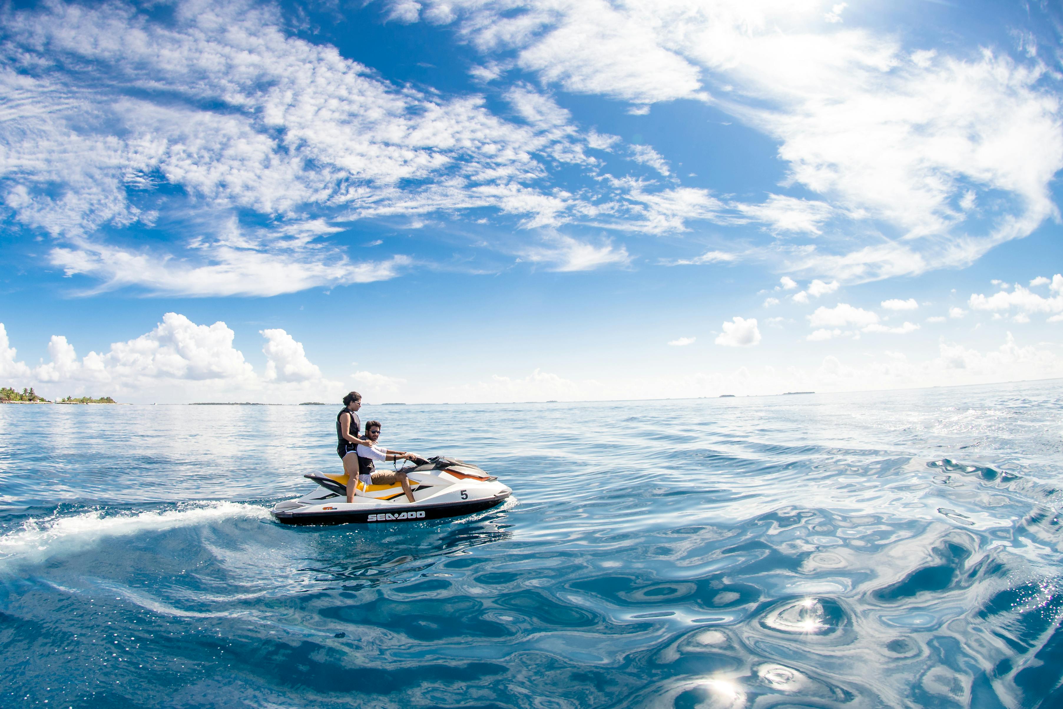 A couple riding a jetski.