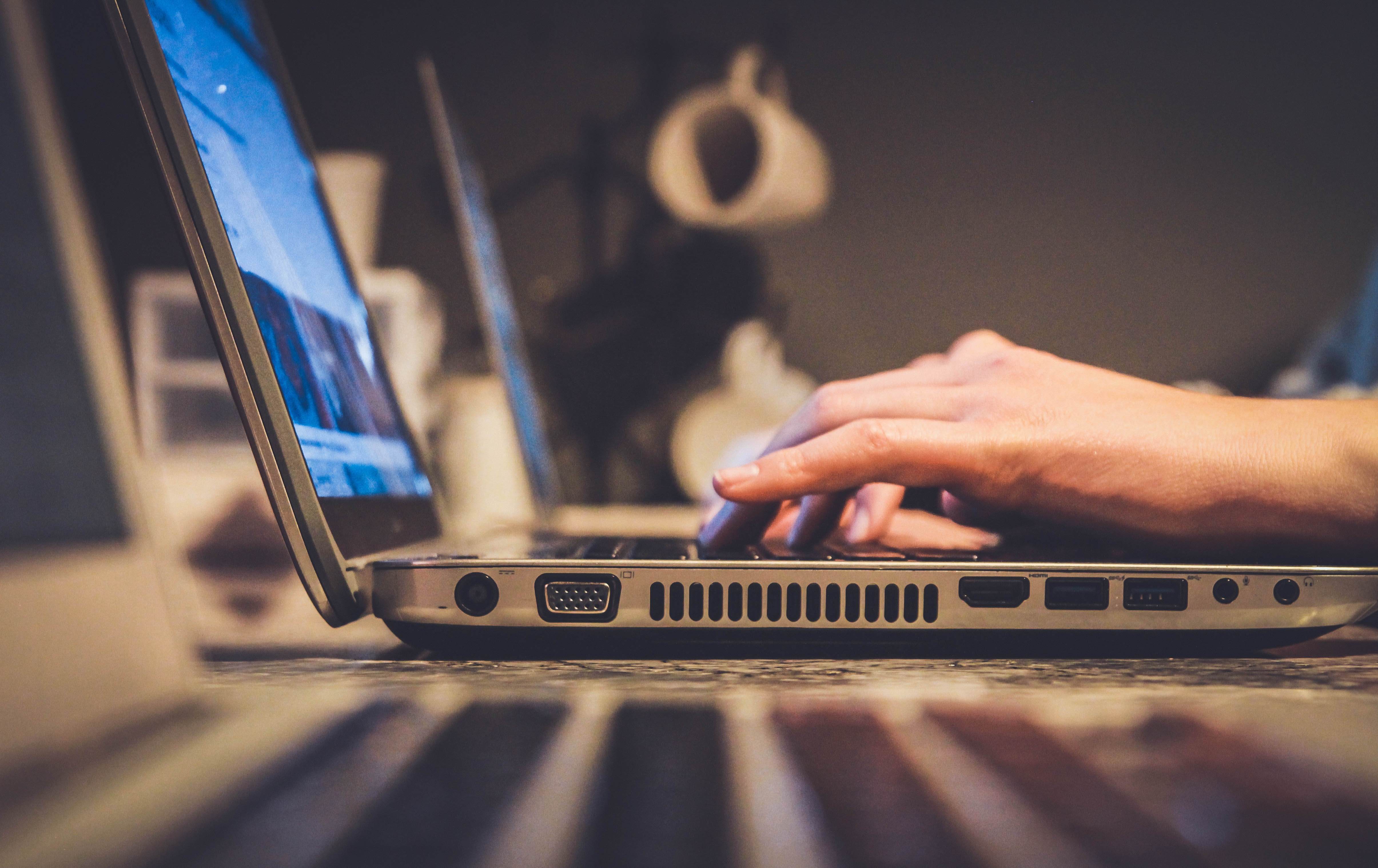 A person listing a boat online using his laptop.