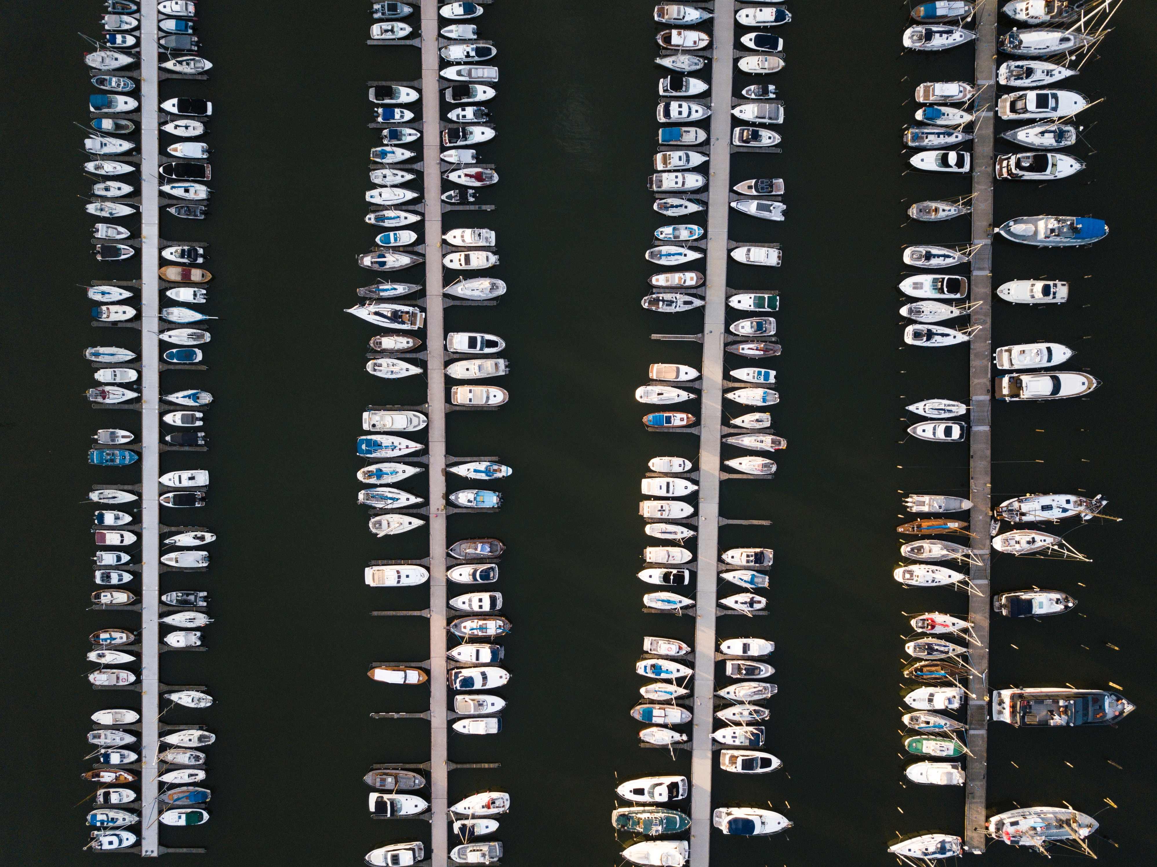 a bird's eye view of a large marina with boats moored to docks.