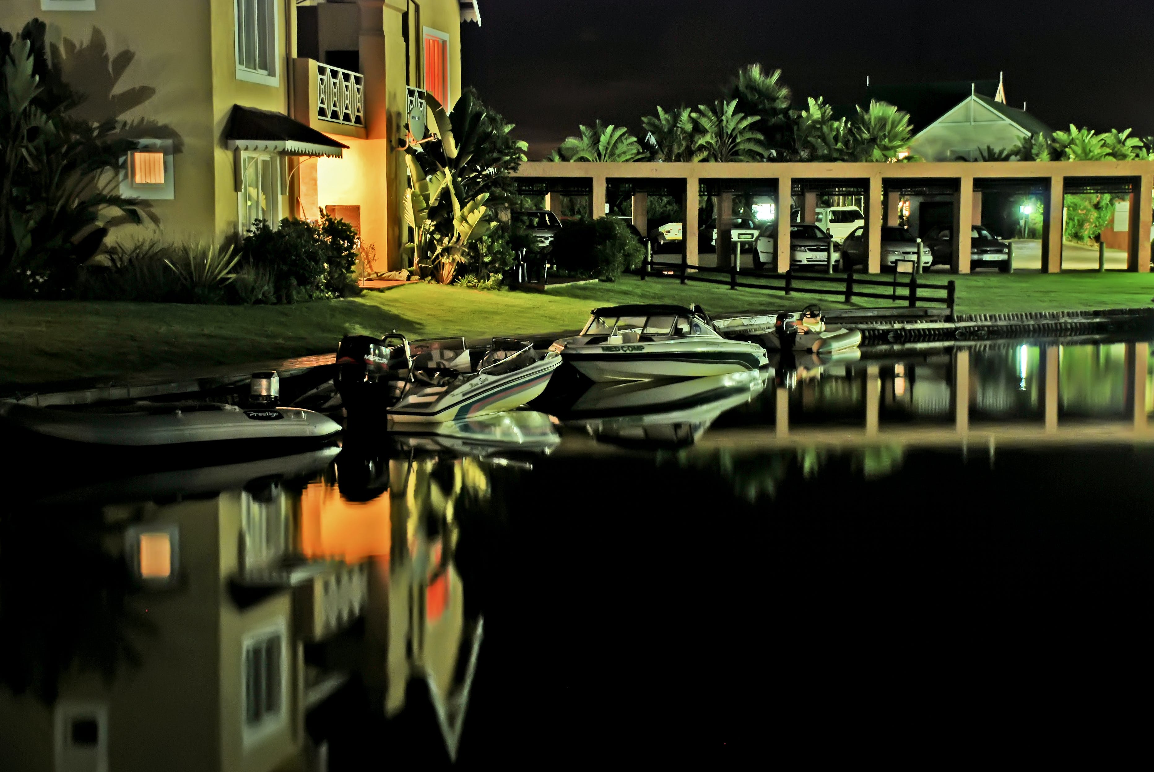 Boats docked near a lakefront property.