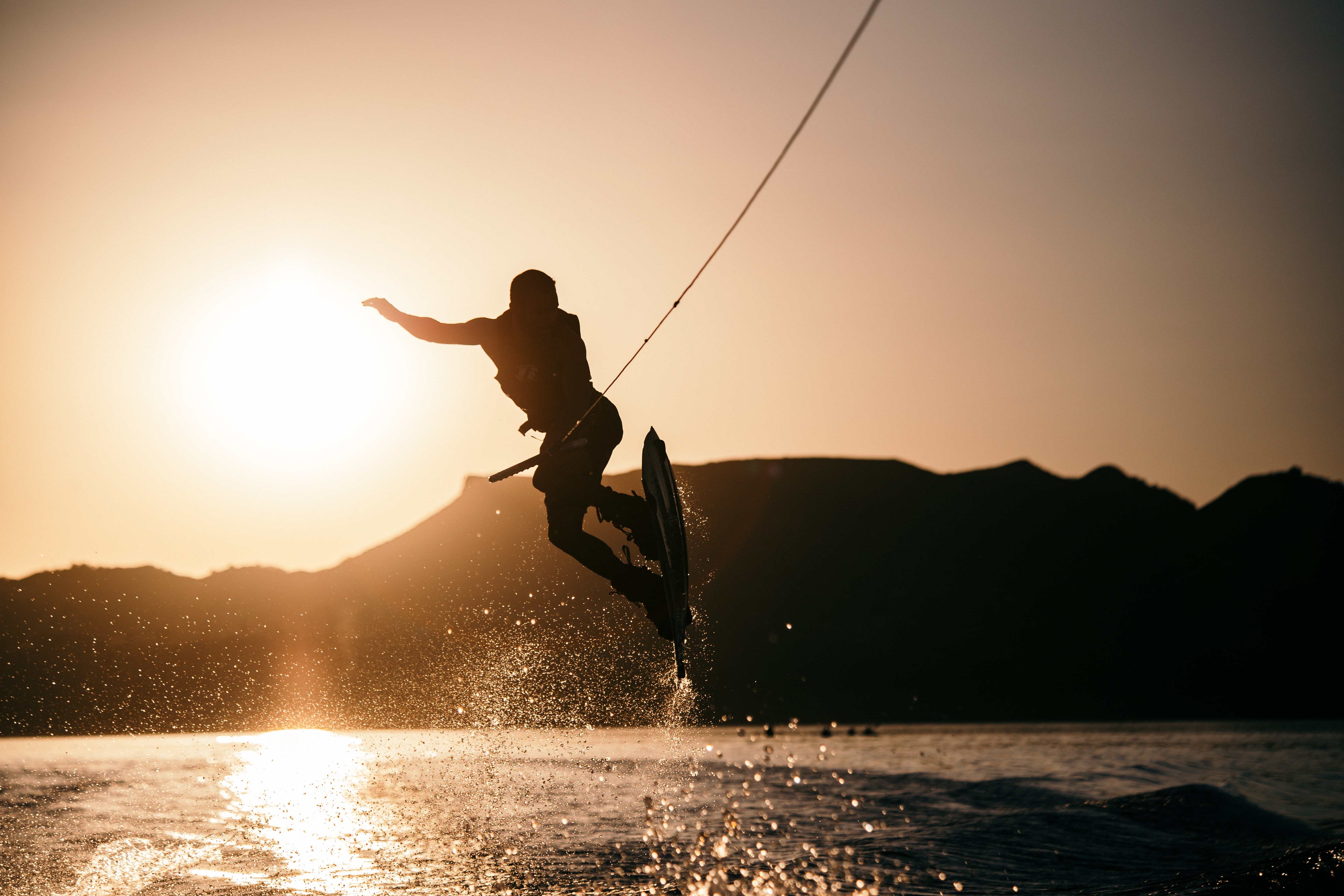 A wakeboarding expert doing tricks on the water.