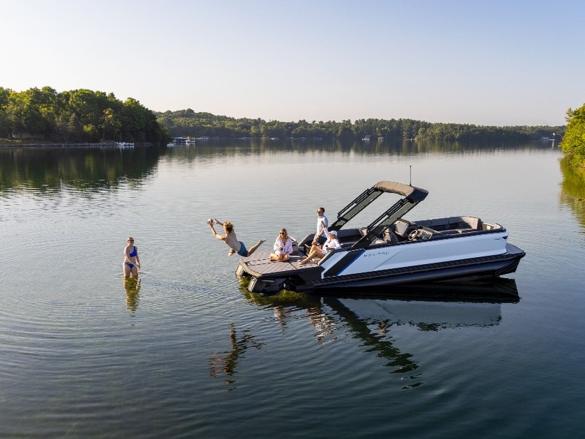 People having fun on a lake while being aboard their Manitou boat.