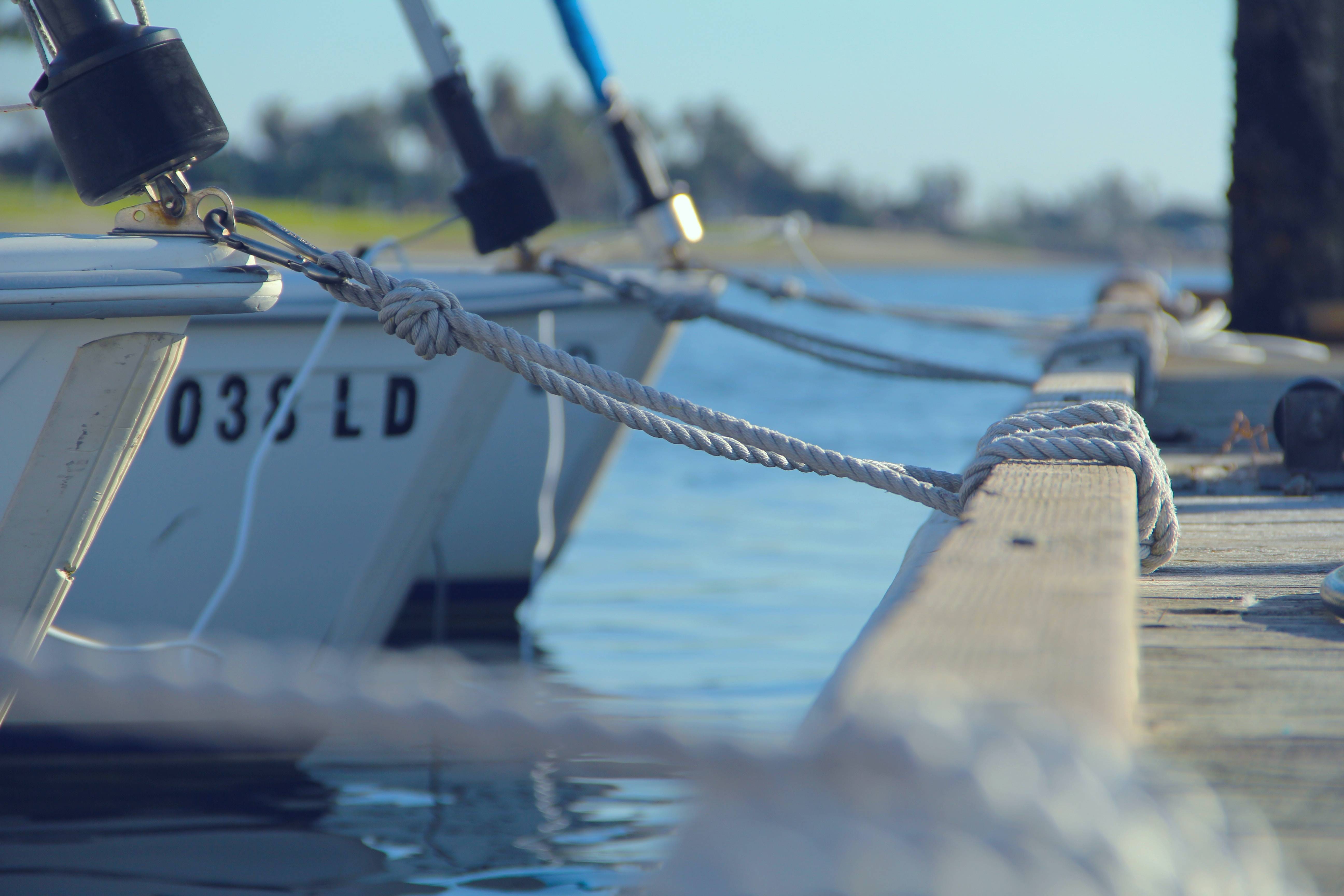 Three boats moored securely in a wharf.