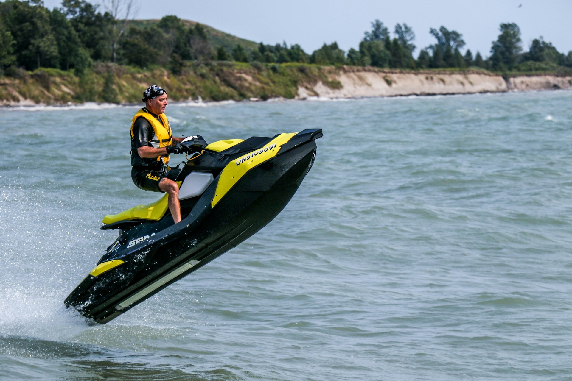 A man doing tricks on a Sea-Doo PWC.