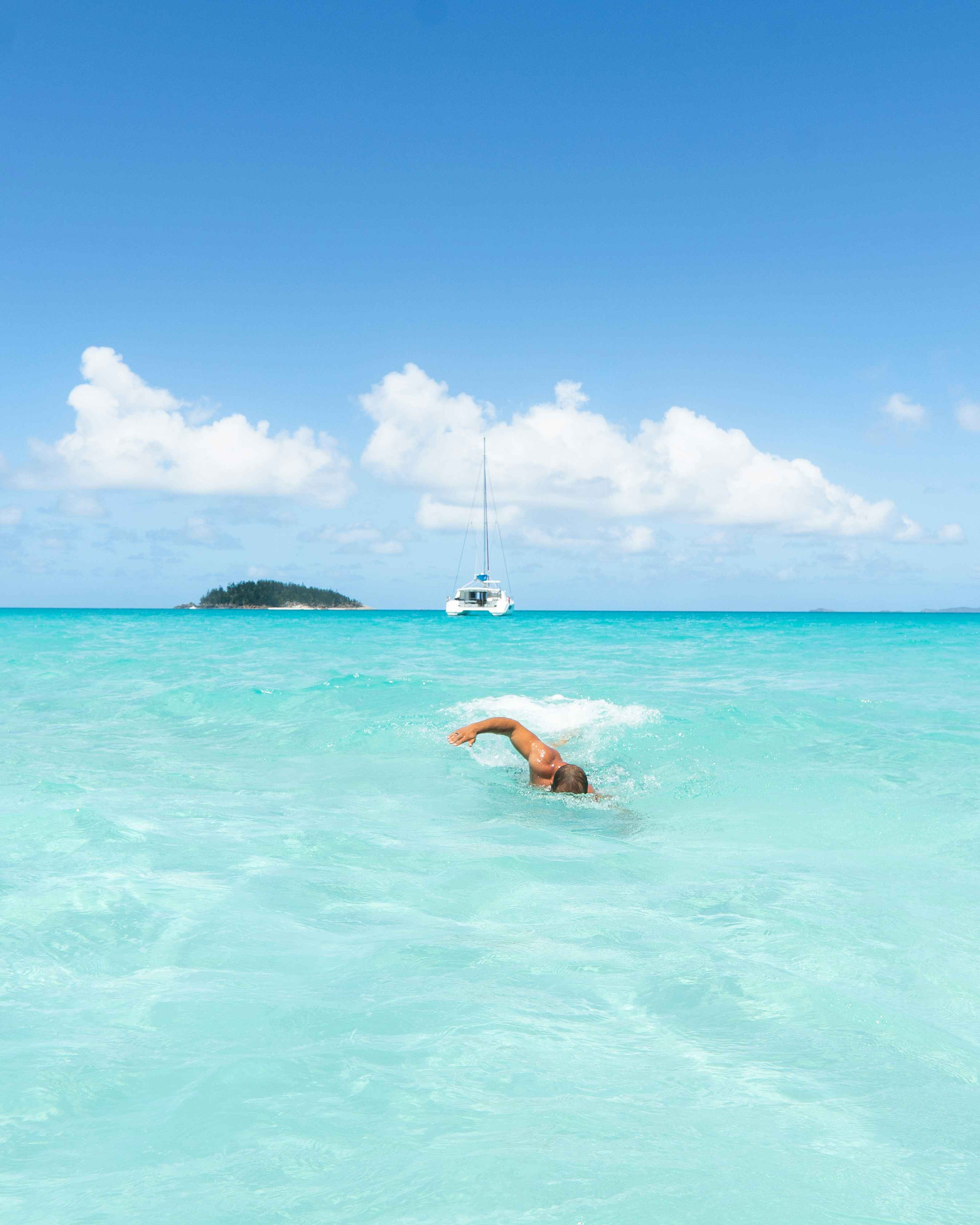 A man swimming near the shore