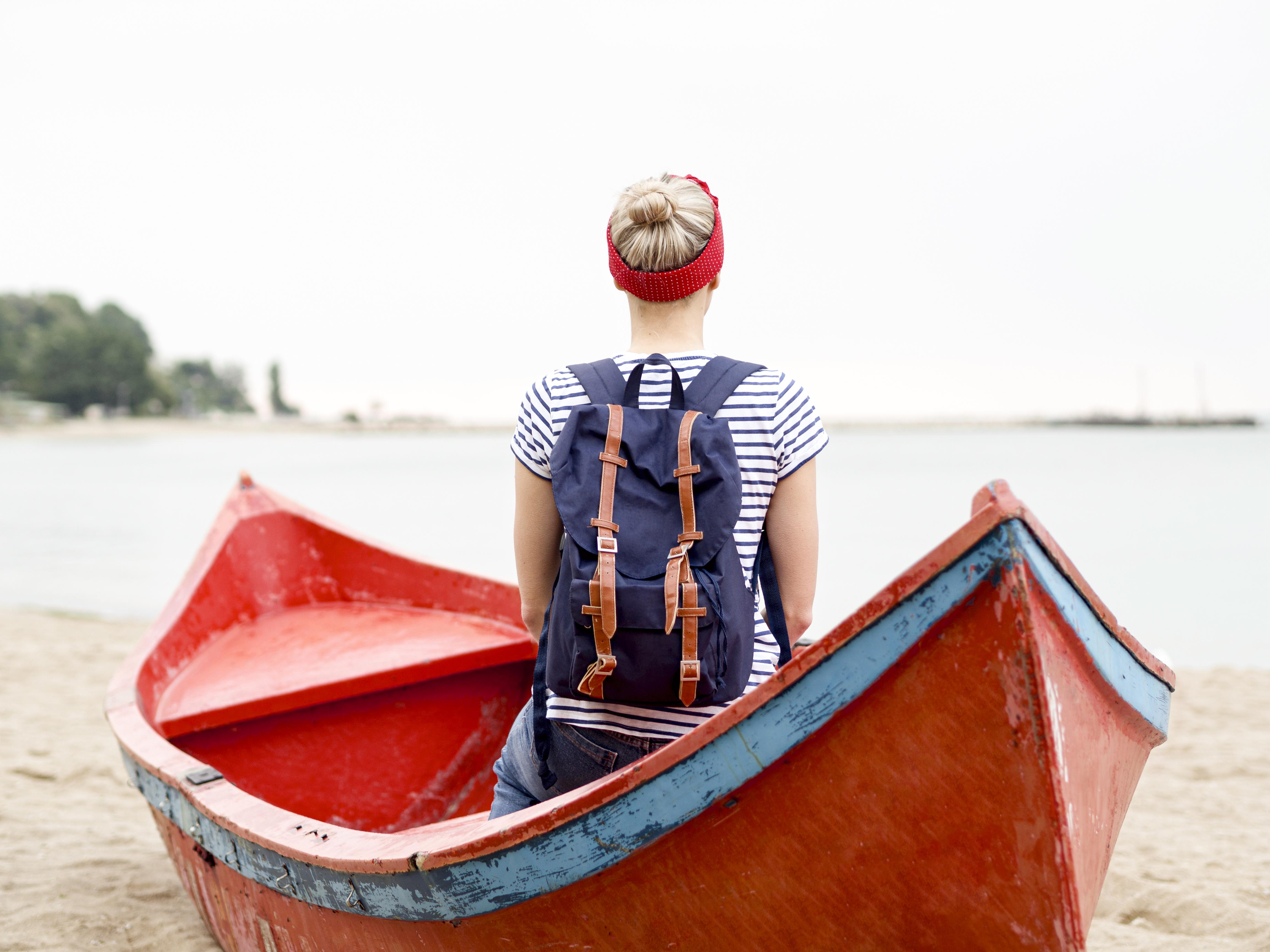 woman wearing a backpack on a boat